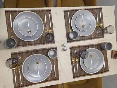 a group of plates and spoons on a table at NEU 2025 Emila Romana Boutique- Modernes Luxury Living in Sunny Beach