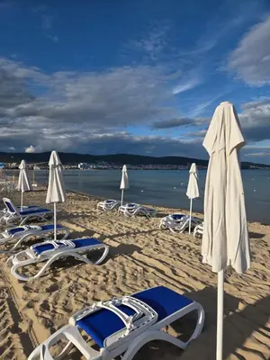 a group of chairs and umbrellas on a beach at NEU 2025 Emila Romana Boutique- Modernes Luxury Living in Sunny Beach