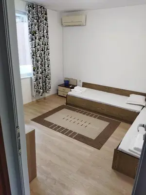 a room with a bed and a rug at Emona 5 floor 3 in Burgas City