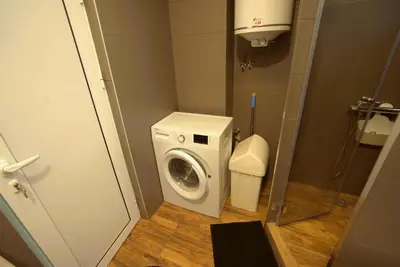 a small bathroom with a washing machine and a toilet at Emona 5 floor 2 in Burgas City