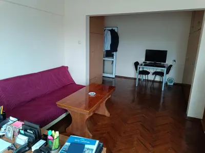 a living room with a couch and a table at Апартамента на центъра на Варна до фонтаните и морето и градинта in Varna City
