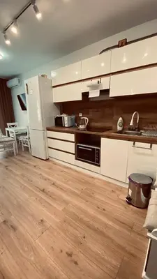 a kitchen with white cabinets and a white refrigerator at Sveti Vlas, Rodopi Bay Apartment in Sveti Vlas