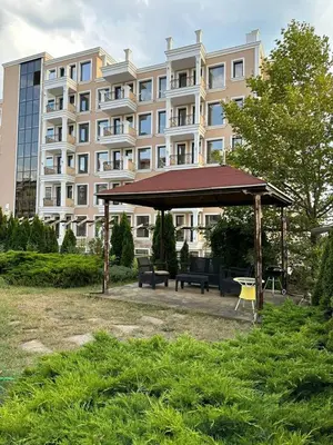a gazebo in a park in front of a building at Sveti Vlas, Rodopi Bay Apartment in Sveti Vlas