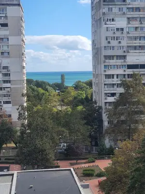 a view of the ocean from between two buildings at Divalla Apartment Burgas in Burgas City