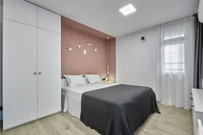 a bedroom with a bed with birds on the wall at Sea Moreto Apartment 3 in Burgas City