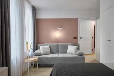 a living room with a couch and a table at Sea Moreto Apartment 3 in Burgas City