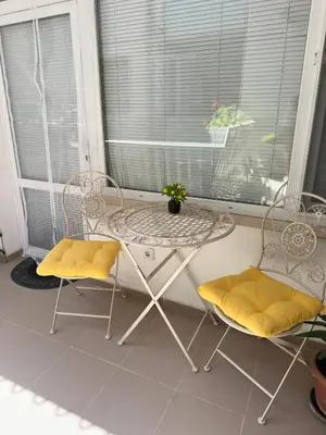 a table and two chairs on a porch at House Velevi in Sveti Vlas