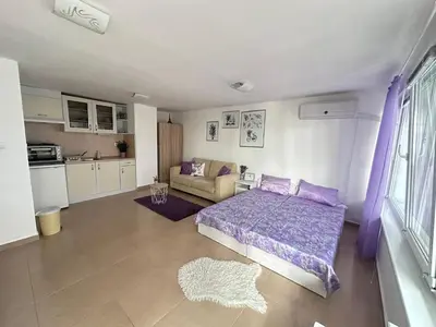a bedroom with a bed and a couch in it at House Velevi in Sveti Vlas