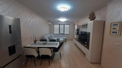 a living room and dining room with a table and chairs at Apartment Tuthon in Pomorie