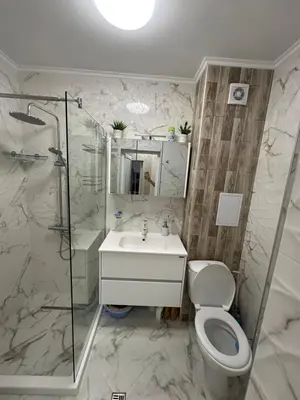 a bathroom with a toilet and a shower and a sink at Apartment Tuthon in Pomorie