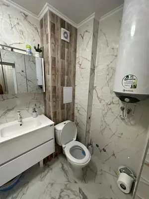 a bathroom with a toilet and a sink at Apartment Tuthon in Pomorie
