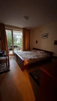 a bedroom with a bed and a large window at Sveti Vlas, Paradise Dreams Apartment in Sveti Vlas