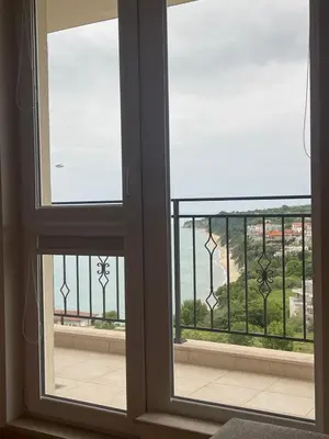 a view of the ocean from a window at Fortuna Cape 4 apartment in Byala