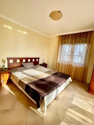 a bedroom with a large bed and a large window at Amara Holiday Santa Marina, Sozopol in Sozopol