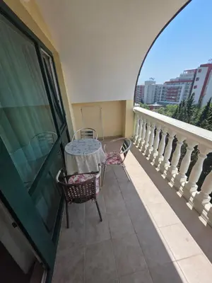 a balcony with a table and chairs and a window at Apartament Hotel Miramar Palace in Sunny Beach