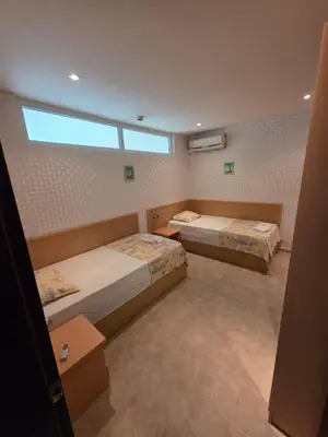 a room with two beds and a window at Apartament Hotel Miramar Palace in Sunny Beach