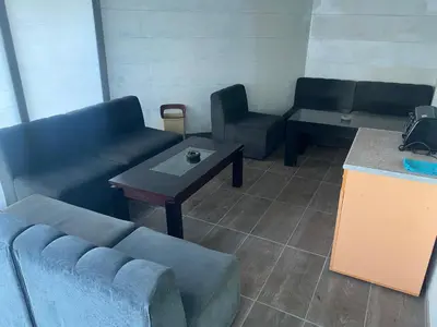 a living room with couches and a table and a counter at Apartments complex Breeze Sunny beach - Апартаменти комплекс Бриз Слънчев бряг in Bŭnzareto
