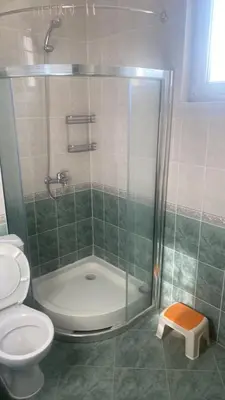 a bathroom with a shower and a toilet at Apartments complex Breeze Sunny beach - Апартаменти комплекс Бриз Слънчев бряг in Bŭnzareto