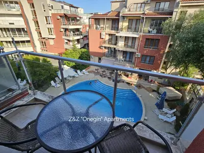 a balcony with a table and chairs and a swimming pool at Z&Z 