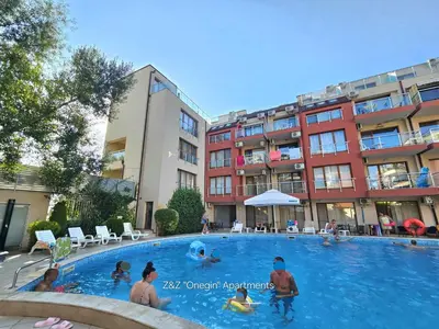 a group of people in a swimming pool with buildings at Z&Z 