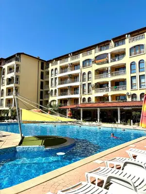 a swimming pool in front of a large building at Royal Dreams Apartments, Sunny Beach in Sunny Beach