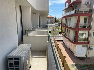 an apartment balcony with a view of a building at Делукс Апартамент Лазур Поморие in Pomorie