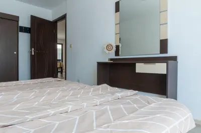 a bedroom with a large bed with a large mirror at Делукс Апартамент Лазур Поморие in Pomorie