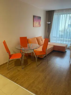 a living room with a couch and a glass table and chairs at Premier Fort Beach Hotel ! in Sveti Vlas