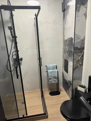 a shower with a glass door in a bathroom at La Terrassa 7 in Burgas City