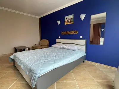 a blue bedroom with a bed and a chair at Quiet 1-Bed Flat in Antonia Complex by Flat Mаnager in Sveti Vlas