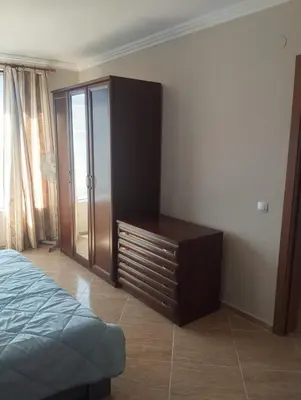 a bedroom with a dresser and a bed in it at Quiet 1-Bed Flat in Antonia Complex by Flat Mаnager in Sveti Vlas
