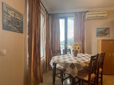 a dining room with a table and a window at Quiet 1-Bed Flat in Antonia Complex by Flat Mаnager in Sveti Vlas