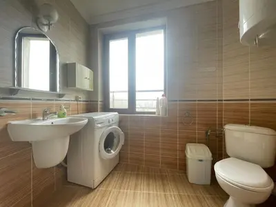 a bathroom with a toilet sink and a washing machine at Quiet 1-Bed Flat in Antonia Complex by Flat Mаnager in Sveti Vlas