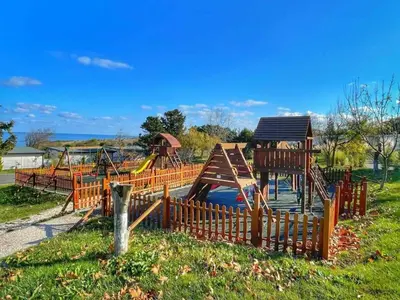 a park with a playground with a slide at Camping Gardenia - Bungalow SeaBed in Lozenets