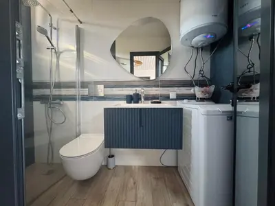 a bathroom with a toilet and a sink and a mirror at Camping Gardenia - Bungalow SeaBed in Lozenets