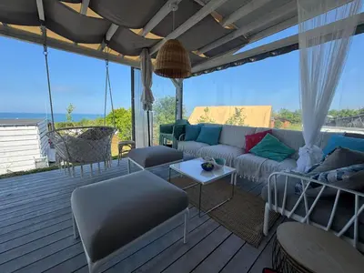 a living room with a couch and chairs on a deck at Camping Gardenia - Bungalow SeaBed in Lozenets