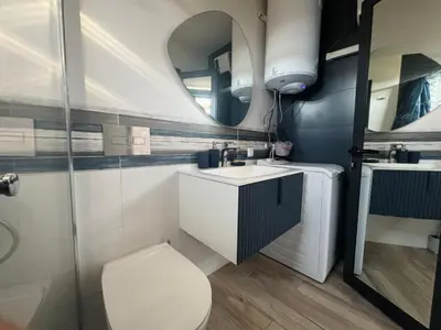 a bathroom with a toilet and a sink and a mirror at Camping Gardenia - Bungalow SeaBed in Lozenets