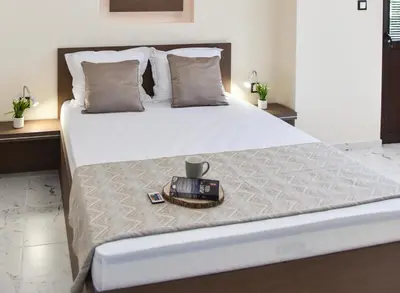 a bed with a tray with a candle on it at Kaleya House in Chernomorets