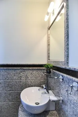 a bathroom with a white sink and a mirror at Kaleya House in Chernomorets
