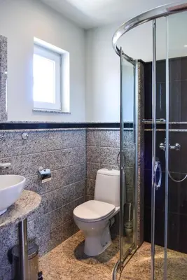 a bathroom with a toilet and a sink and a shower at Kaleya House in Chernomorets