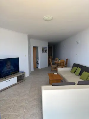 a living room with a couch and a flat screen tv at Vega View in Sveti Vlas