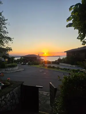 an empty street with the sunset in the background at Sozopolis Sunset Apartment with sea view in Sozopol