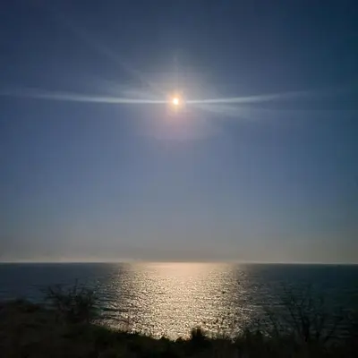 a view of the ocean with the sun in the sky at Sozopolis Sunset Apartment with sea view in Sozopol