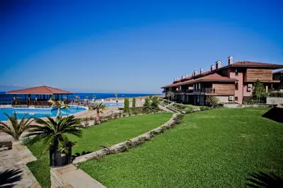 a resort with a lawn and a swimming pool at Sozopolis Sunset Apartment with sea view in Sozopol