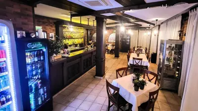 a restaurant with two tables and a bar at Studio Comfort Blue in Primorsko