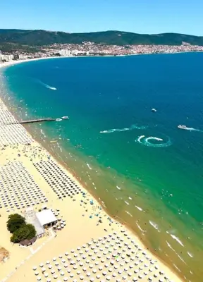 a view of a beach with umbrellas and the ocean at Sunny Day 6 in Sunny Beach