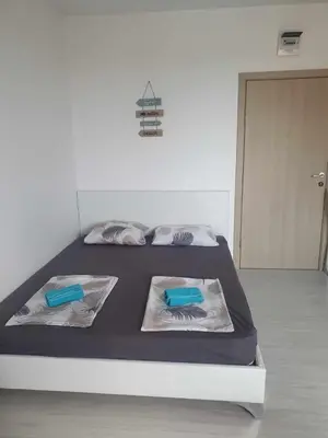 a bedroom with a bed with blue sheets and blue pillows at Sunny Day 6 in Sunny Beach