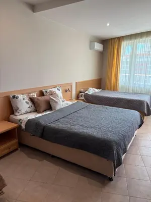 a bedroom with two beds and a window at Miramar Palace 615 in Sunny Beach
