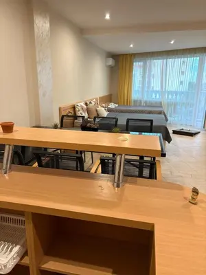 a living room with a bed and tables in a room at Miramar Palace 615 in Sunny Beach