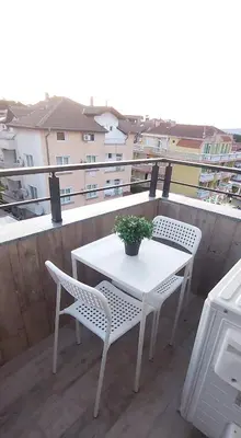 a white table and chairs on a balcony at Апартамент ReLax Китен in Kiten
